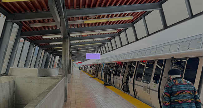 BART waiting area with rider information visible across several competing surfaces.